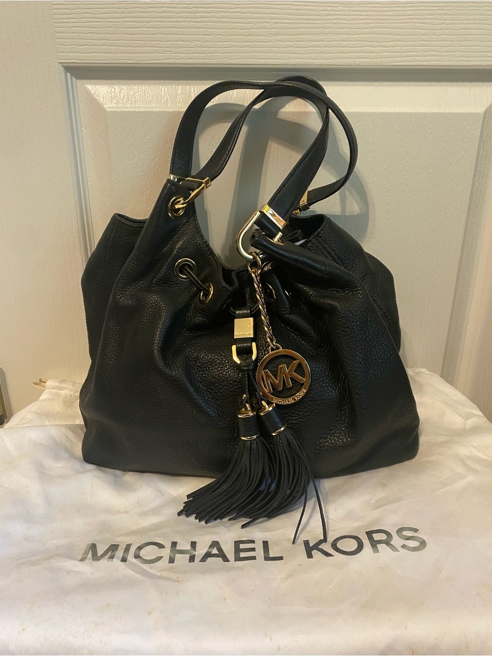 Michael Kors Black Leather Hobo with Gold Hardware and Tassel Charm